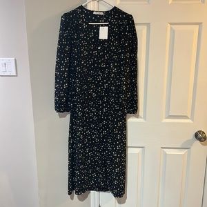 NWT.  Beautiful flowy midi dress.  Black with small floral pattern.